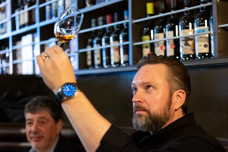 Nick Roady evaluating a whiskey at the bar